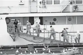  ?? MEGAN PACER/HOMER NEWS VIA AP ?? Staff from South Peninsula Hospital and Homer Public Health board the Tustumena to test 35 crew members and six passengers Monday at the Homer Ferry Terminal in Alaska.