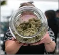  ?? The Canadian Press ?? A vendor displays marijuana for sale during the 4-20 annual marijuana celebratio­n.