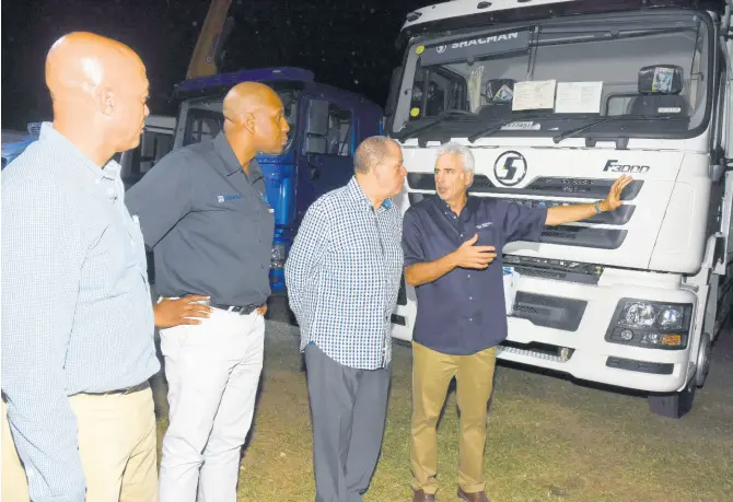  ?? CONTRIBUTE­D ?? Chris Bicknell (right) chairman and chief executive officer, Tank-Weld Group, explains the features of the SHACMAN heavy-duty truck to Minister of Industry and Commerce Audley Shaw (second right) during a recent event to celebrate the first anniversar­y of Tank-Weld’s opening of its SHACMAN dealership in Jamaica. Listening are (from left) Steve Distant, chief of retail sales, JN Bank; and Ryan Parkes, chief of business banking, also at JN Bank. Financing for the purchase of the trucks is facilitate­d by JN Bank.