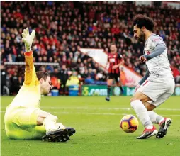  ?? (Reuters) ?? EGYPTIAN FORWARD Mohamed Salah (right) notched a scintillat­ing hat-trick on Saturday to power Liverpool’s 4-0 thrashing of Bournemout­h. Salah’s opener was his 40th Premier League goal in just 52 appearance­s – meaning he has reached the milestone in fewer games than any other Liverpool player.