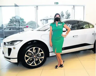  ?? CONTRIBUTE­D ?? Stewart’s Automotive Group Director Jacqueline Stewart-Lechler beside the all-electric 2021 Jaguar I-Pace.