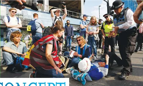  ?? Photo: AFP ?? City of London police speak with activists from the climate change protest group Extinction Rebellion as they block Blackfriar­s Bridge in London on April 15, 2022.