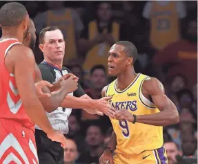  ?? JAYNE KAMIN-ONCEA/USA TODAY SPORTS ?? Lakers guard Rajon Rondo throws a punch at Rockets guard Chris Paul. Rondo was one of punished by the NBA, but he is being applauded by fans in L.A.