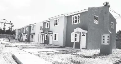  ??  ?? This April 2010 file photo shows NHT houses under developmen­t in St Catherine.