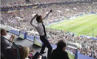  ??  ?? President Emmanuel Macron celebrates the opening goal by France in grand style