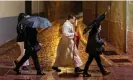  ?? ?? A penitent walks along the street after his procession was suspended due to heavy rain in the north-west Spanish city of Zamora on Wednesday. Photograph: César Manso/AFP/ Getty Images