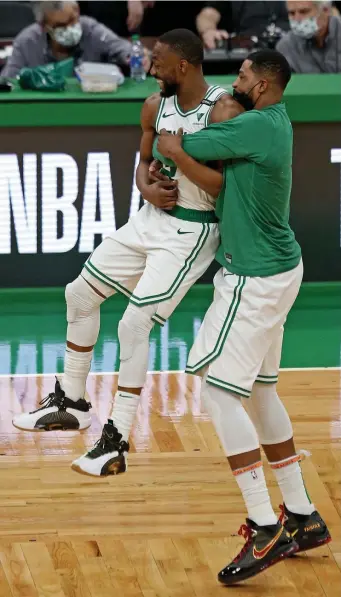  ?? Stuart CaHill / Herald staFF ?? BACK ON TRACK: Celtics forward Tristan Thompson picks up guard Kemba Walker in the final minutes of the Celtics’ 118-112 win over the Pacers at the Garden on Friday.