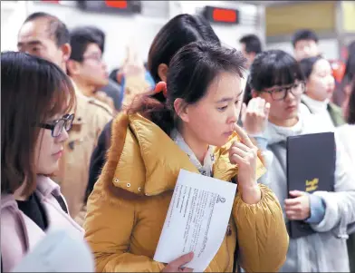  ?? ZOU HONG / CHINA DAILY ?? College students attend a job fair in Beijing on Monday. There are expected to be nearly 8 million new graduates in China this year.