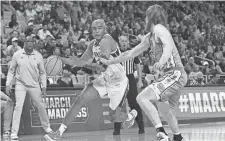  ?? PENNINGTON/ GETTY IMAGES ?? Baylor’s Jeremy Sochan (1) dribbles the ball as North Carolina’s Brady Manek (45) defends during a second-round NCAA Tournament game on March 19. TOM