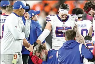  ?? JOSHUA A. BICKEL / AP, FILE ?? Buffalo Bills players and staff pray for Buffalo Bills’ Damar Hamlin during the first half of an NFL football game against the Cincinnati Bengals on Jan. 2 in Cincinnati.