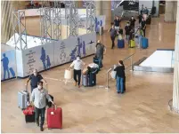  ?? (Flash90) ?? PASSENGERS ARRIVE at Ben-Gurion Airport last month.