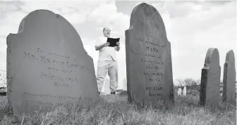  ?? THE ASSOCIATED PRESS ?? Dead Poets Society of America founder Walter Skold reads a Henry Wadsworth Longfellow poem in Eastern Cemetery in Portland, Maine.