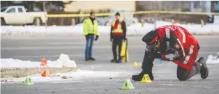  ?? AZIN GHAFFARI ?? Calgary police investigat­e the scene Friday where Sgt. Andrew Harnett, left, was struck the night before by a vehicle fleeing a traffic stop on Falconridg­e Boulevard and Falconridg­e Drive N.E. in Calgary.