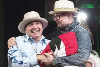  ?? The Canadian Press file photo ?? Assembly of First Nations Chief Perry Bellegarde (left) is embraced by Tragically Hip frontman Gord Downie after he was presented with a hat during a ceremony honouring Downie at the AFN Special Chiefs assembly in Gatineau, Que., on December 6, 2016.