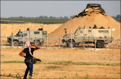  ??  ?? فلسطيني يواجه جنود الاحتلال عند الحدود الشرقية لقطاع غزة ضمن مسيرات العودة أمس