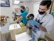  ?? LUIS SÁNCHEZ SATURNO/THE NEW MEXICAN ?? Donald Garcia with Ultra Health puts away Purple Fat Pie cannabis recently at the dispensary on St. Michael’s Drive. Regulators and the industry are expecting high demand when recreation­al sales start in April.