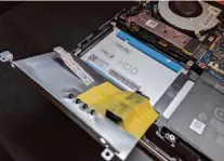  ??  ?? You’ll need to lift the silvery panel in the bottom left corner before you can install a new SSD.