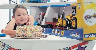  ?? RICHARD HUTTON METROLAND ?? Alexzander Carriere eyes a birthday cake that was just for him at an event marking the fifth anniversar­y of the Niagara Health’s St. Catharines hospital. Alexzander was the first baby born at the hospital.