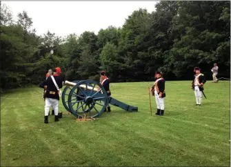  ?? FILE PHOTO ?? Re-enactors prepare to fire a cannon during a previous naturaliza­tion ceremony.