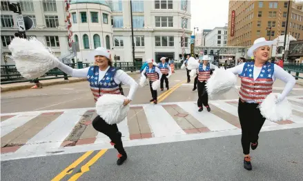 ?? KENNY YOO/AP ?? Colleen Minisce, left, and Janet Polley lead other Milwaukee Dancing Grannies at a Veterans Day parade Nov. 5 in Milwaukee.