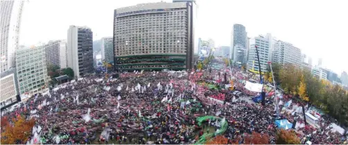  ??  ?? SEOUL: This long exposure photograph shows protesters marching towards the presidenti­al house during an anti-government rally in central Seoul yesterday. Tens of thousands of men, women and children joined one of the largest anti-government protests...