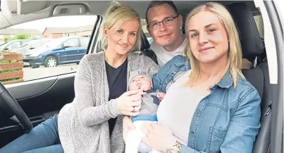  ?? SWNS. Picture: ?? Aldona Biewald, left, with new mum Milena, dad Andrzej Biewald and their baby son Maksymilia­n who was born in the car outside their home.