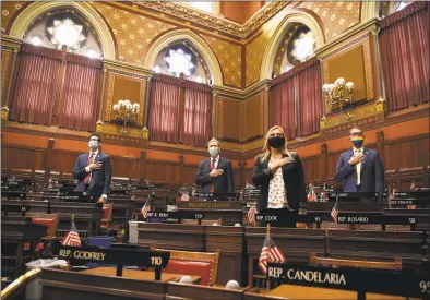  ?? Jessica Hill / Associated Press ?? Connecticu­t House Majority Leader Matt Ritter, D- Hartford, second from left, stands with fellow Democrats in the House, as they stand for the Pledge of Allegiance during the start of a special session at the State Capitol on Thursday in Hartford.