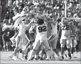  ?? AP/JASON E. MICZEK ?? Carolina Panthers players, including Cam Newton (1), celebrate Graham Gano’s game-winning, 63-yard field goal that helped defeat the New York Giants 33-31 on Sunday in Charlotte, N.C.