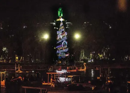  ?? Photo by Jean Nicole Cortes ?? LIGHT IT UP. Baguio City’s Christmas tree lights up the surroundin­g of Burnham Park, particular­ly at the lake which resonates the Christmas vibe in the City of Pines.