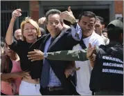  ?? WIL RIERA — THE ASSOCIATED PRESS ?? Venezuelan General Prosecutor Luisa Ortega Diaz, left, is surrounded by loyal employees, as she was barred from entering headquarte­rs in Caracas, Venezuela on Saturday. The constituti­onal assembly removed her from office and replaced her with a staunch...