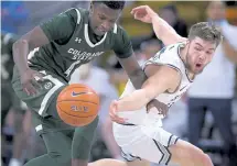  ?? Eli Lucero, The Herald Journal ?? Utah State guard Rollie Worster, right, battles with Colorado State guard Isaiah Stevens during a game last month.