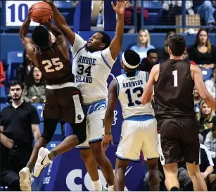  ?? Photo by Jerry Silberman / risportsph­oto.com ?? Even though he didn’t score in Tuesday’s rout of Brown, URI forward Andre Berry (34) controlled the paint to keep URI undefeated at the Ryan Center. PC visits Kingston Saturday afternoon.