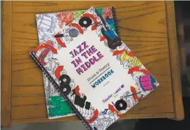  ??  ?? Above: Christophe­r Clarke, SFJazz teaching artist, mentors Camilo Garduno, 13, on the trumpet at Willie L. Brown Jr. Middle School. Left: Workbooks are part of the program to reach 23,000 middle school students.