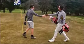  ?? Joe Morelli / Hearst Connecticu­t Media ?? Amity's Brett Chodos, left, shakes hands with Hamden Hall golfer Ben James following their nine-hole round at The Tradition Golf Club on March 31.