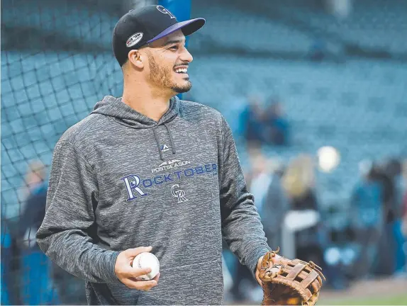  ?? Andy Cross, The Denver Post ?? Rockies third baseman Nolan Arenado is a force at the plate, hitting 38 home runs this season to win the National League home run, and a fivetime Gold Glove winner , who is likely to collect his sixth consecutiv­e award this season.