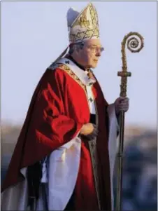  ?? RICK RYCROFT — THE ASSOCIATED PRESS FILE ?? In this file photo, Cardinal George Pell walks onto the stage for the opening mass for World Youth Day in Sydney, Australia. Australian police say they are charging Pell with historical sexual assault offenses.