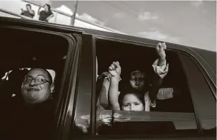  ??  ?? Two girls raise their fists during a protest cruise July 11 through southeast Houston calling for a congressio­nal investigat­ion into the killing and alleged sexual harassment of Guillén at Fort Hood. The fellow soldier blamed in her death later killed himself.