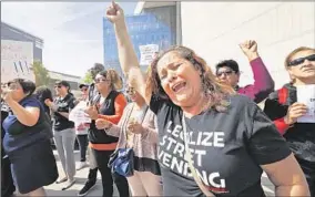  ?? Al Seib
Los Angeles Times ?? STREET VENDOR CARIDAD VASQUEZ joins other vendors at a news conference in front of LAPD headquarte­rs in March to demand an end to police harassment.