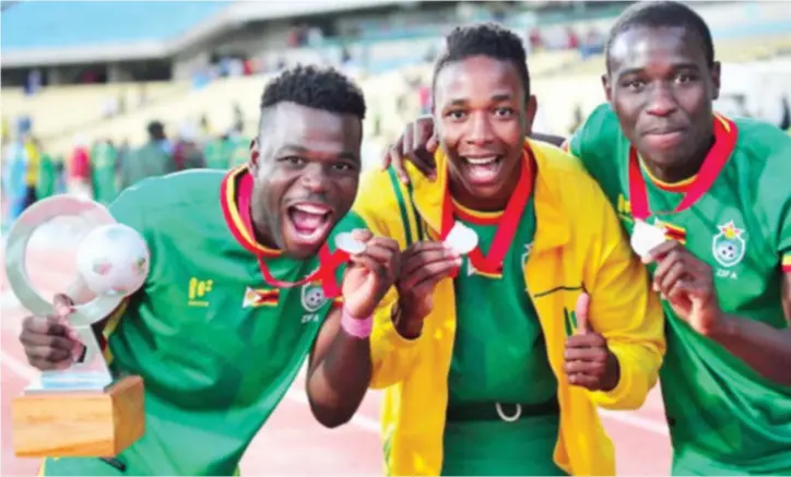  ??  ?? TRIUMPHANT WARRIORS . . . Members of the victorious Zimbabwe senior men’s national team (from left) Knox Mutizwa, Prince Dube and Honest Moyo celebrate winning the COSAFA Cup last year in South Africa