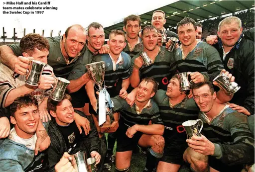  ??  ?? > Mike Hall and his Cardiff team-mates celebrate winning the Swalec Cup in 1997