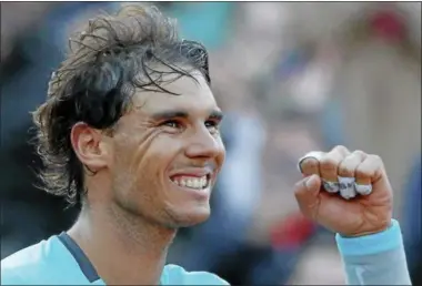  ?? MiChEL EuLER — ThE ASSOCiATED PRESS ?? Rafael Nadal celebrates winning the quarterfin­al match of the French Open tennis tournament against David Ferrer at the Roland Garros stadium, in Paris, Wednesday, Nadal won in four sets 4-6, 6-4, 6-0, 6-1.