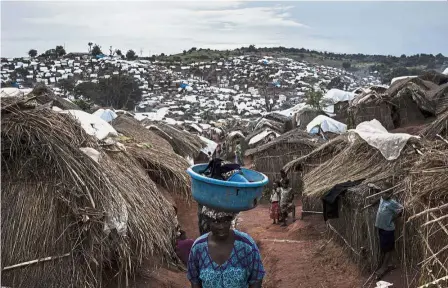  ?? — AFP ?? Deadly cycle: A Congolese woman walking through a camp for Internally Displaced Persons amid renewed violence in Kalemie, Democratic Republic of the Congo.