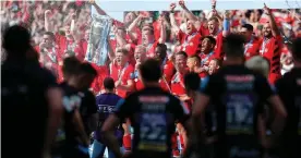  ?? Photograph: Darren Staples/PA Images ?? Exeter players look on as Owen Farrell lifts the trophy as he and his Saracens teammates celebrate beating Exeter 37–34 in the Premiershi­p final in June 2019.