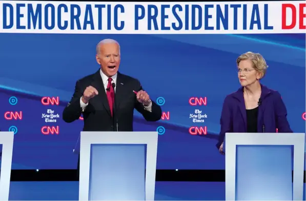  ?? (Shannon Stapleton/Reuters) ?? SEN. ELIZABETH WARREN listens to former vice president Joe Biden during the fourth US Democratic presidenti­al candidates 2020 debate in Westervill­e, Ohio, last week.