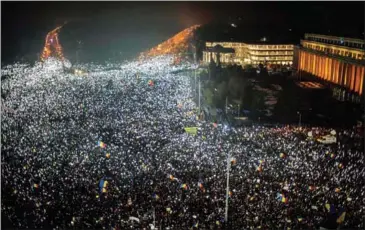  ?? ANDREI PUNGOVSCHI/AFP ?? Demonstrat­ors turn on the lights of their mobile phones as they protest against the Romanian government’s contentiou­s corruption decree in front of the government headquarte­rs at the Victoriei square in Bucharest on February 5.