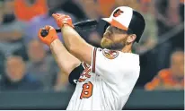  ?? ASSOCIATED PRESS FILE PHOTO ?? Baltimore’s Chris Davis follows through on a two-run home run against the White Sox in 2019. Once one of baseball’s top home run hitters, Davis announced his retirement Thursday.