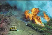  ?? STAFF FILE PHOTO ?? Firefighte­rs man a fire line as they work to control the Loma fire in the Santa Cruz Mountains in September 2016 .