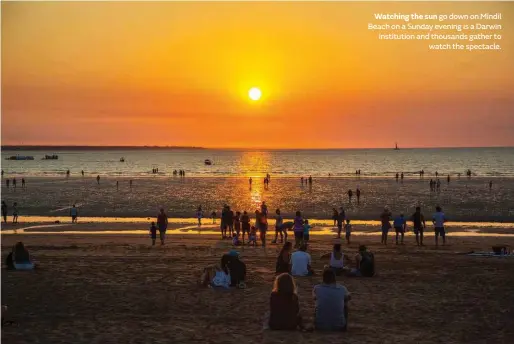  ??  ?? Watching the sun go down on Mindil Beach on a Sunday evening is a Darwin institutio­n and thousands gather to watch the spectacle.