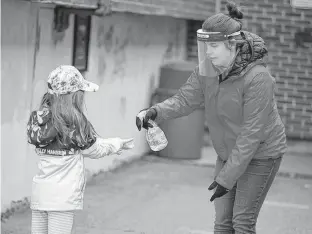  ?? CHRISTINNE MUSCHI • REUTERS ?? A student has her hands sanitized in the schoolyard in Saint-Jean-sur-Richelieu, Que., on May 11.