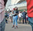  ??  ?? Cori Bush speaks on a bullhorn to protesters outside the St. Louis Police headquarte­rs Sunday.